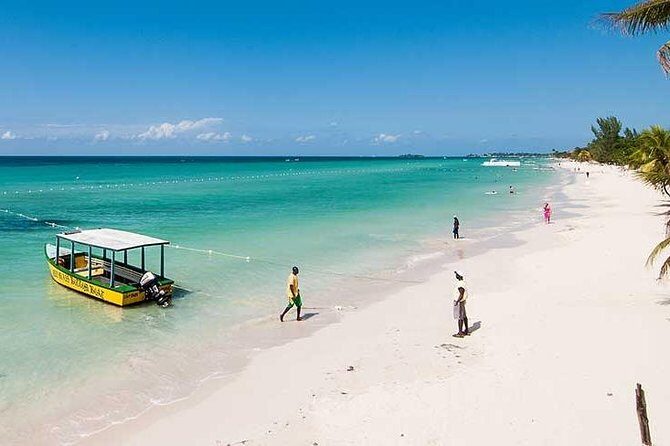 Blue Hole Mineral Spring, Ricks Cafe, 7 Mile Beach and Shopping Private Tour - Stop 2: Seven Mile Beach Time for Sun, Swim, and Easy Vibes